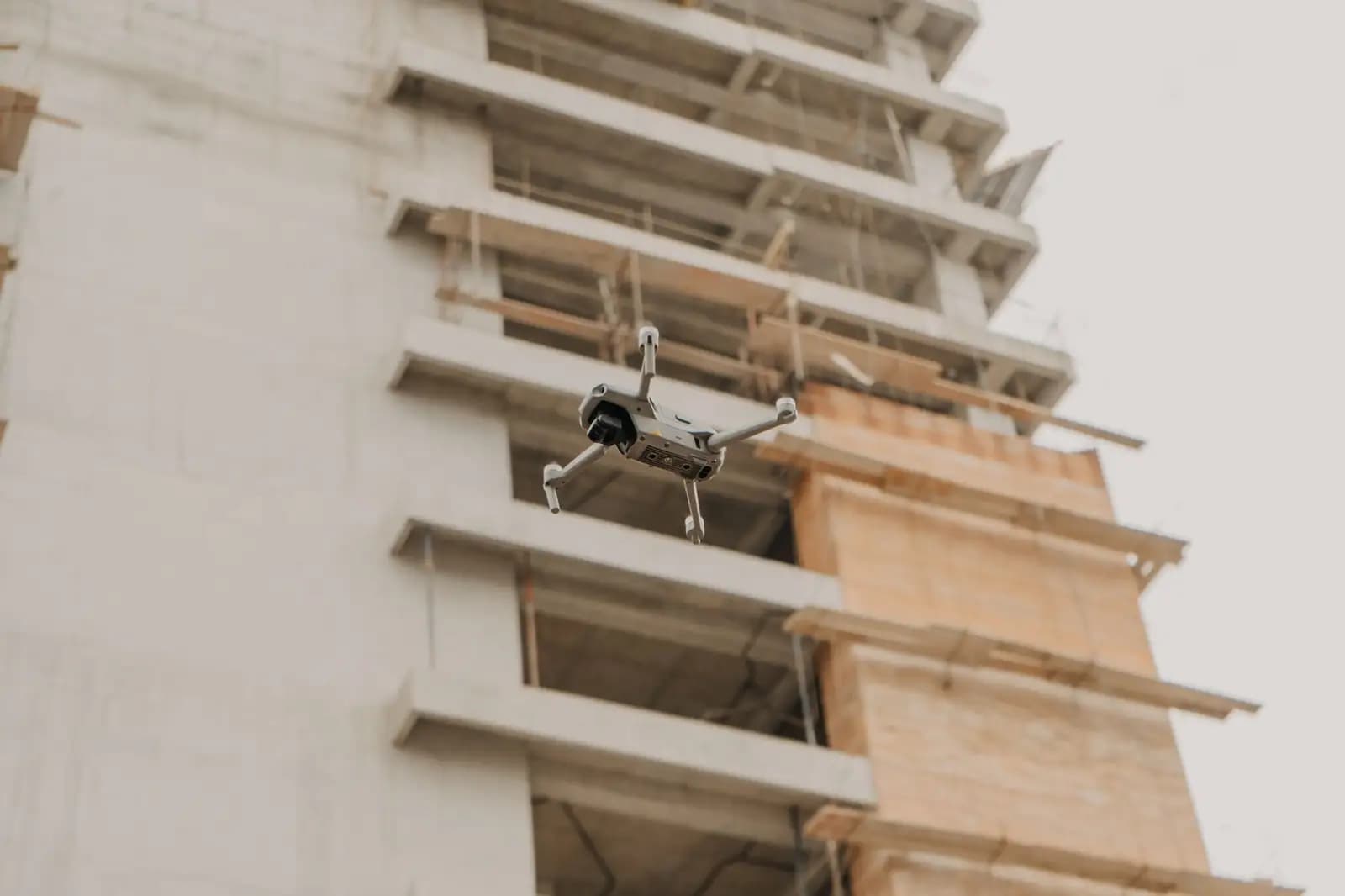 Drone terbang di atas proyek konstruksi pemerintah dengan latar belakang gedung